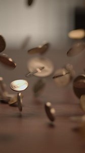 Coins Falling on a Surface An Exploration of Currency and its Implications in Economics