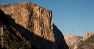 Yosemite National Park, California, USA - view of El Capitan and Half Dome in the background from Tunnel View before sunset with moving shadows - Timelapse with pan right to left