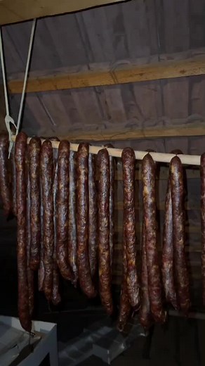 Traditional Sausages Hanging in Rustic Smokehouse