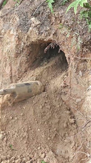 Manual Shovel Digs Through Dirt Slope Cave Entrance: Mounds of Soil Pile Up!