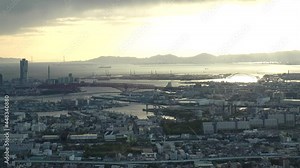 OSAKA, JAPAN : Aerial high angle sunset view of CITYSCAPE of OSAKA. View of buildings and street traffic around Osaka bay and Kobe port. Wide view real time shot in dusk.