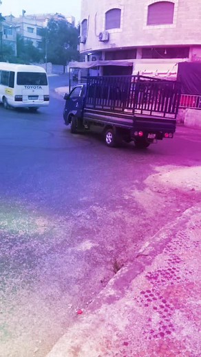 Blue Toyota Pickup Truck Driving Through Suburbs