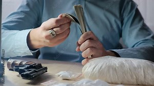Drug dealer counting money. Drug trafficking and shadow business on drug trafficking