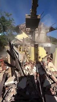 House Demolition With an Excavator