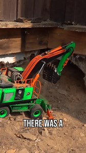 An excavator makes quick work of clearing away a rotten deck and assorted debris. The corner needs some serious repair, but the heavy equipment is up to the task of hauling away the old wood and fiberglass. The land is being reclaimed one scoop at a time. #excavator #deckremoval #cleanup #repair #reclaimingland | RCSparks Studio