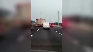 A semi truck on a freeway swerves to block other drivers from passing in this scene from Road Wars. | A&E