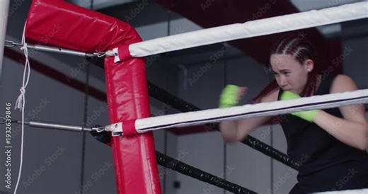The female athlete flows through shadow fighting exercises, emphasizing fast footwork, sharp punches, and flawless form to elevate her boxing performance.