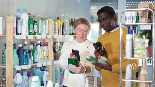 Couple adult man and woman buyers scanning qr code for dishwashing detergent in household chemicals store