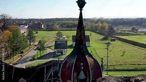 The top of a medieval castle in a small village in Vojvodina with a wonderful background of a couple of fields and houses
