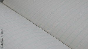 School scrap book white surface slow pan 4K 2160p 30fps UltraHD footage - Close-up of squared paper notebook writing pages 3840X2160 UHD panning video