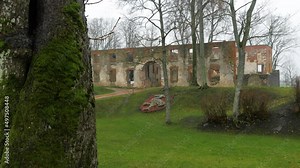 Grobina medieval castle (located in Grobina, Latvia) ruins on an overcast autumn day, built by Livonian Order, leafless trees, wide shot
