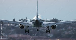 Cinematic back rear view of landing big airplane 4K footage for tourism business