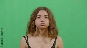 Woman Inflating The Cheeks. Studio Isolated Shot Against Green Screen Background