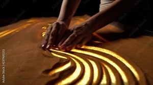 girl makes sand patterns on the table, sand animation