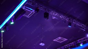 Night club lights out of focus. They blink and rotate on a blue background. Club life.