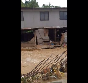 Eroding house begins sliding as floodwaters rage in Consolacion, Cebu, Philippines