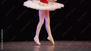 A ballerina dances en pointe on stage during a performance.
