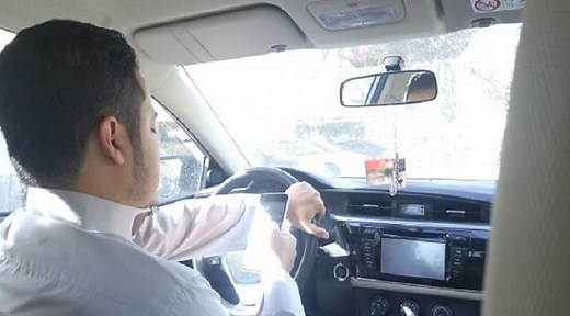 How much fine for using mobile while driving?