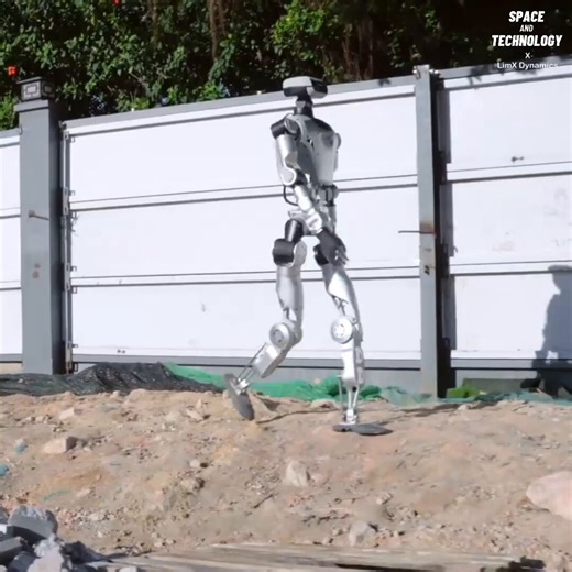Oli, a humanoid robot by LimX Dynamics, can walk across rough construction debris without losing balance. It can even hit a rock and quickly recover while continuing forward. Using 3D cameras, LiDAR, and sensors, it maps the area and adjusts its steps to move safely.