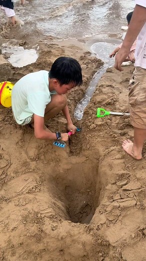 18M views · 10K reactions | Children enjoying a day at the beach, digging a deep hole in the sand with excitement. They carve out a small canal leading to the sea, and as they dig, the ocean water begins to flow through the canal, filling the hole. Their laughter and joy grow as the water rushes in, creating a mini-pool. A perfect day of fun, creativity, and exploration at the beach, where imagination meets the wonders of nature. | Creative Child | Facebook