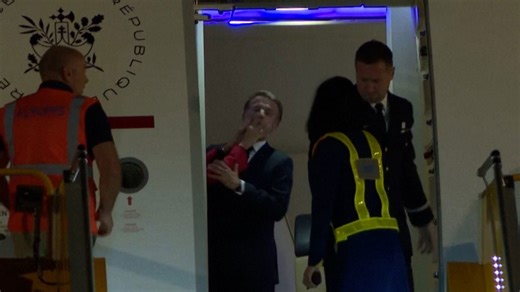 Macron's wife pushes him in the face on plane