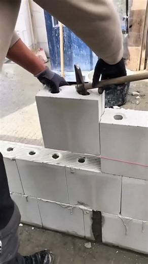 Expert Bricklaying Using a Hammer for Perfect Block Placement