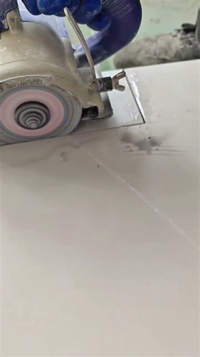Close-up of a Worker Cutting and Polishing Ceramic Tile with a Wet Grinder