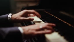 close up of hands playing the piano