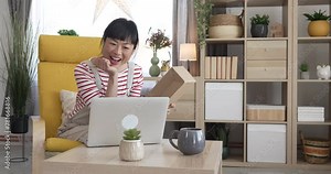 Japanese woman check box of received package or product at home