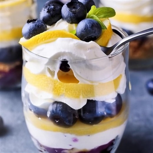 Lemon Blueberry Parfaits These Lemon Blueberry Parfaits are a delightful and refreshing no-bake dessert, ideal for summer gatherings. Featuring layers of smooth lemon curd, luscious blueberry syrup, and airy whipped cream, this treat is quick to prepare and naturally gluten-free. Ingredients Blueberry Syrup: - 1 cup (222 g) fresh or frozen blueberries - 1/3 cup (83.33 ml) water - 1/4 cup (50 g) granulated sugar Whipped Cream: - 2 cups (476 ml) heavy cream - 1/3 cup (84.75 g) honey Other: - 1 cup