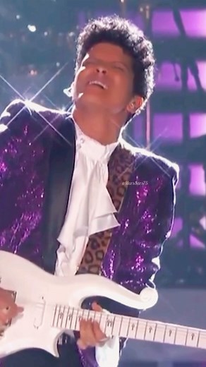 🔥 This guitar solo! 🔥 @brunomars paid a tribute to @prince at the 59th Annual Grammy Awards. The guitar he played is one of the original guitars of Prince himself 🎸💜 • Today marks 9 years since we lost one of the worlds greatest musical geniuses, @prince 💜 21-04-2016 - 21-04-2025 🕊️ He was one of Bruno’s inspirations and heroes 🙏🏽👑 May he Rest In Peace 🕊️💜 • • 🎶 Let’s Go Crazy 📅 February 12, 2017 📍 Staples Center in Los Angeles • • • #BrunoMars #Prince #PrinceTribute #Grammy #Gramm