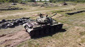 Military Tank Maneuvering through a Training Ground Surrounded by Other Armored Vehicles and Tires Stock Video - Video of combat, defense: 382328689