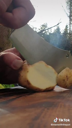 Outdoor Cooking in Nature with Knife: Men with the Pot