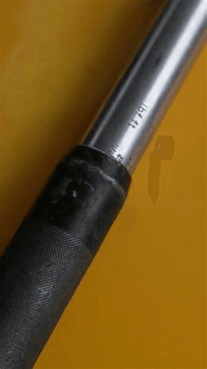 clip-3971504971-worker-uses-torque-wrench-close-up-mechanic-blue