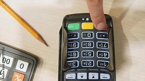 Cancel puyment credit card terminal. Buyer cancels the transaction. Finger pushing the cancel button on pin pad card reader close-up