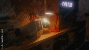 No people interior shot of old computer monitor, boombox, disco ball and lamp on shelf in garage, 90s aesthetics