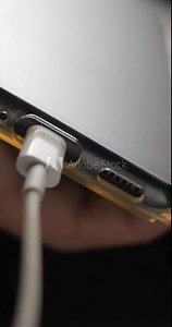 USB-C cable macro plugin to smartphone slow motion, vertical view