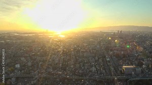 OSAKA, JAPAN : Aerial high angle sunrise view of CITYSCAPE of OSAKA. View of buildings and street traffic around Osaka bay and Kobe port. Long time lapse wide tracking shot, night to morning.