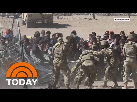 Video shows migrants push through part of southern border fence