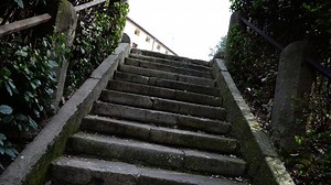 Outdated grey stairs with brown metal rusty handrails