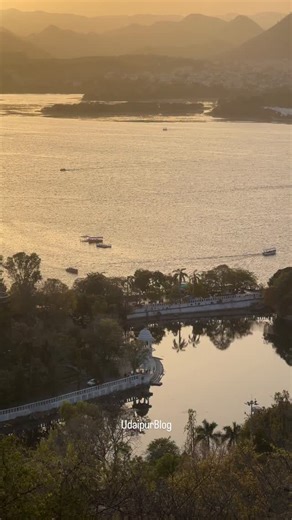 The city of Lakes is turning into the city of golden hour.🧡 [ Udaipur City, Heritage Lane, Colorful Streets, Culture, Travel, Rajasthan Vibes, Postcard City, Serene Walk, Architecture, Lakeside Charm] #udaipur #ub #udaipurblog #cityoflakes #udaipurtourism | UdaipurBlog