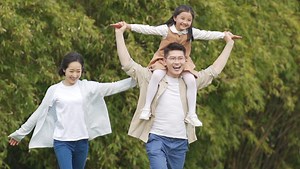 A family running happily in slow motion