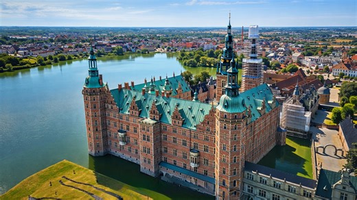 A castle built right along the edge of a lake in Denmark