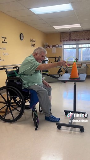 Seated core training for seniors doesn’t have to be basic. In this video my patient is performing resisted trunk flexion using a theraband secured to the wheelchair. We’re targeting anterior core strength, postural control, and dynamic sitting balance. 🔹 Version 1: Reaching for rings stacking over cones This adds coordination, visual tracking, fine motor control, and problem-solving. Now it’s not just core work — it’s functional reaching, midline control, and task-specific training. This transl