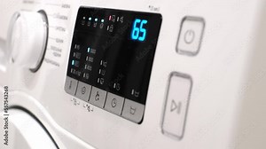 Close-up of manually turning on the washing machine. Washing clothes.