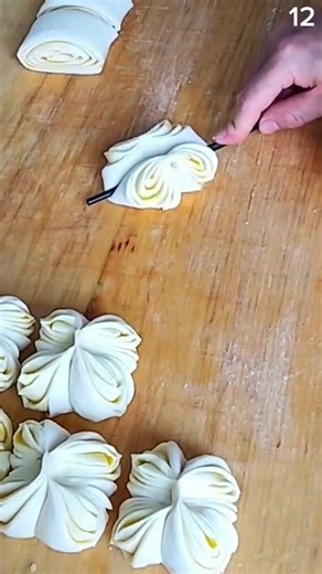 Shaping laminated dough into flower patterns, crisp rhythm of morning bakery craft