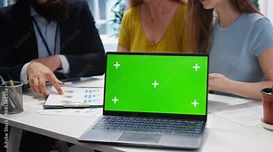 Financial adviser assisting clients in setting up investment accounts with isolated screen laptop, close up. Consultant uses financial planning software on chroma key notebook to help family, camera A