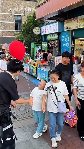 The kind brother gave the ball to the boy.
