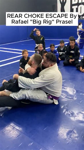 REAR CHOKE ESCAPE - Rafael “Big Rig” Prasel — Rear-Naked-Choke Escape (Total MMA Studios, Tustin, CA) When most people panic in a rear naked choke, Big Rig shows how to solve it with technique, not strength. From back control, he straightens the choking arm to kill the angle, forces the attacker to switch the arm to the opposite side, then steps and rotates away—sliding his hips out and dropping into half guard where he can breathe, base, and rebuild. Key details to watch: • Don’t fight the sque