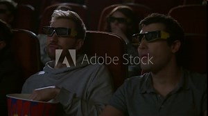 Man eating popcorn in 3d cinema. Friends taking popcorn from pop corn box. Guy giving popcorn to friend. Spectators enjoy cinema snacks